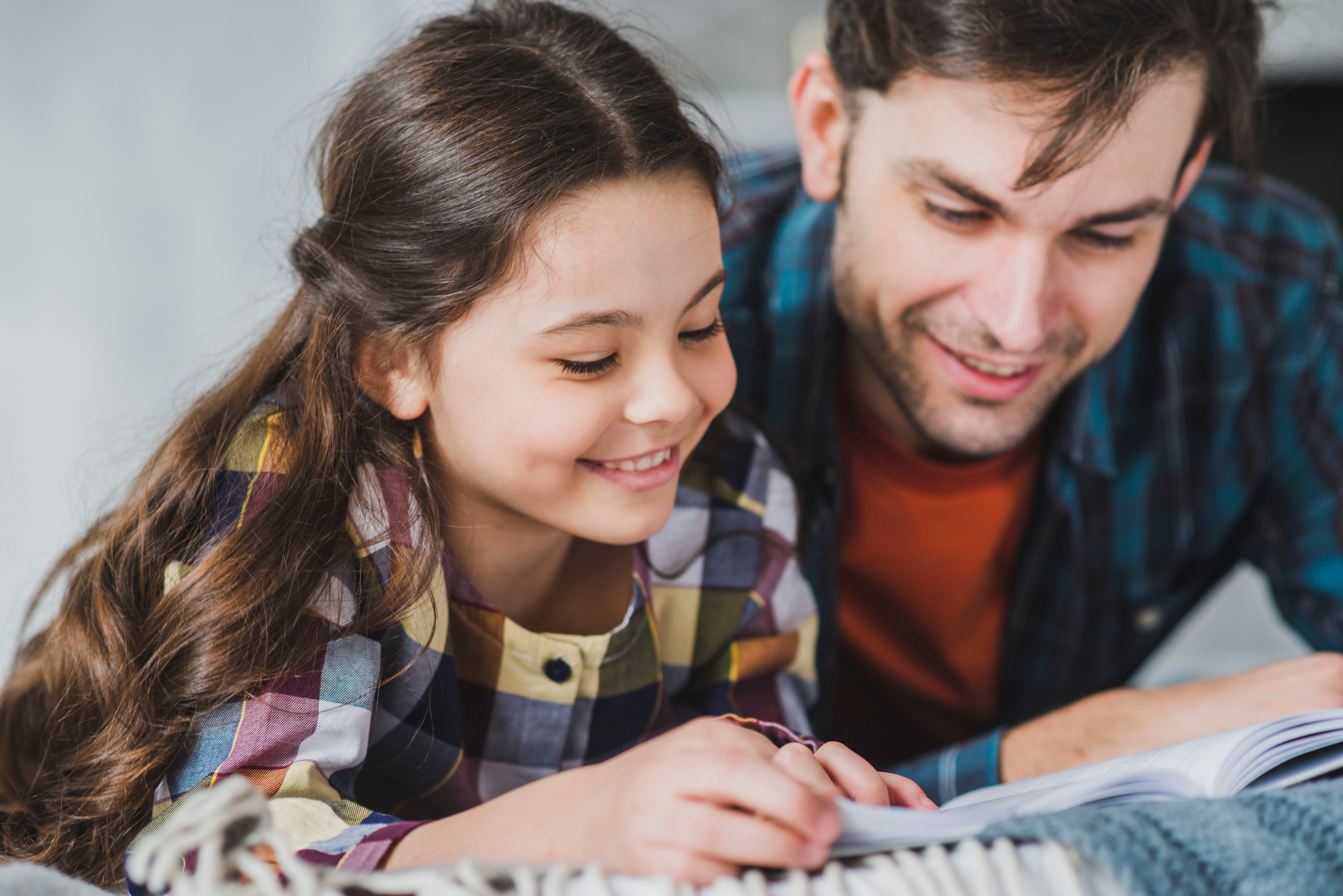 Father reading with daughter