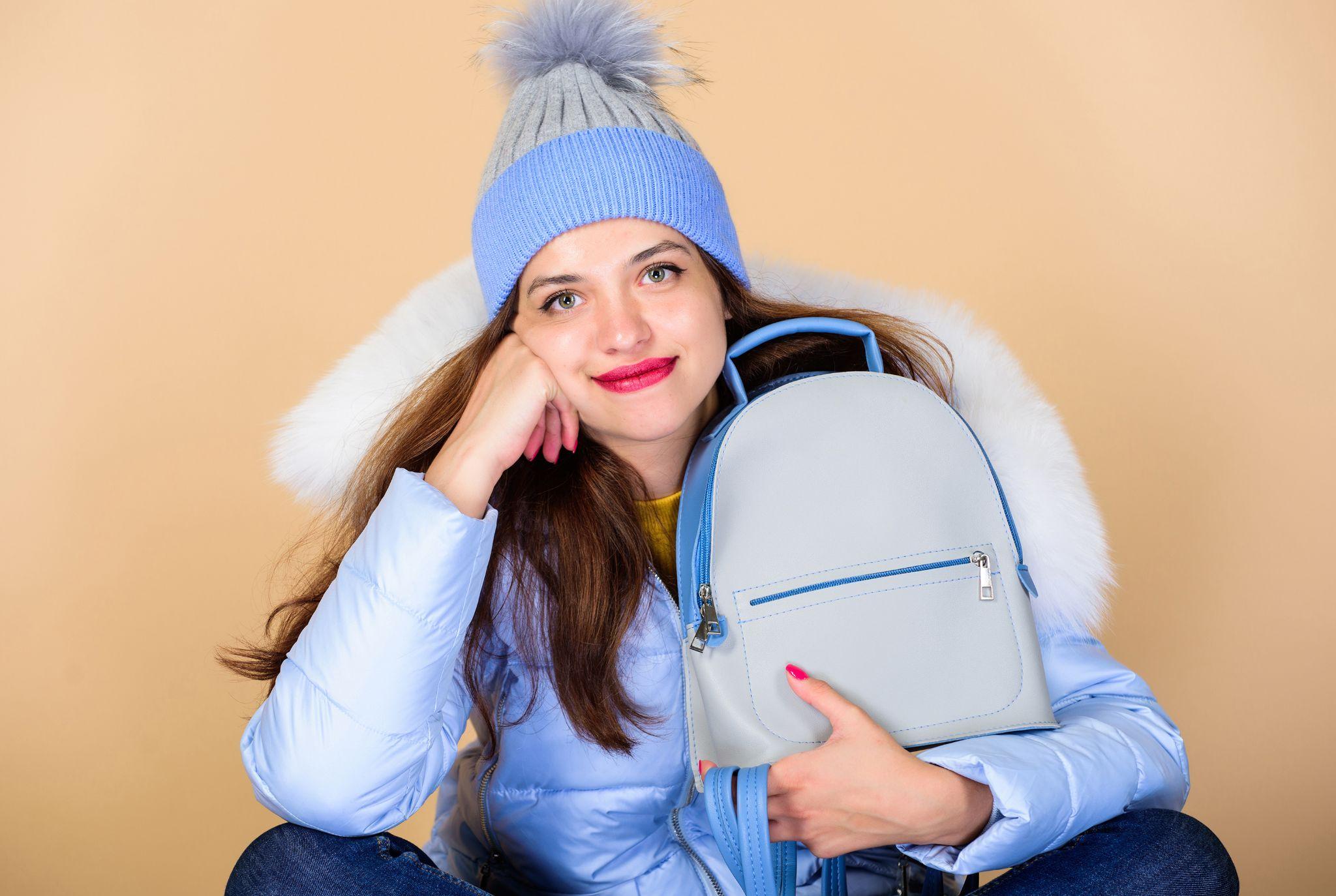 child wearing a hoodie holding a bag